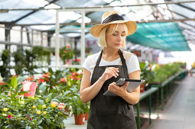 Medium shot woman holding tablet