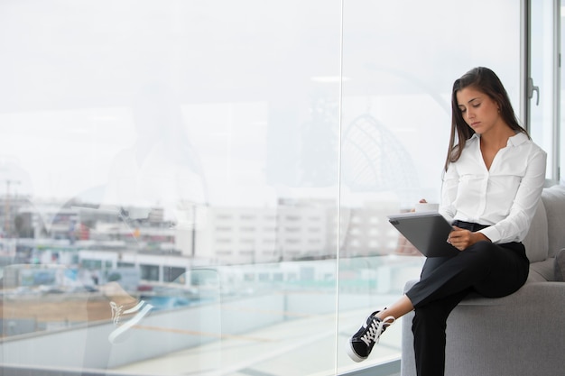 Medium shot woman holding tablet