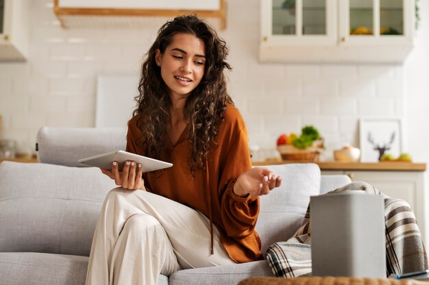 Medium shot woman holding tablet