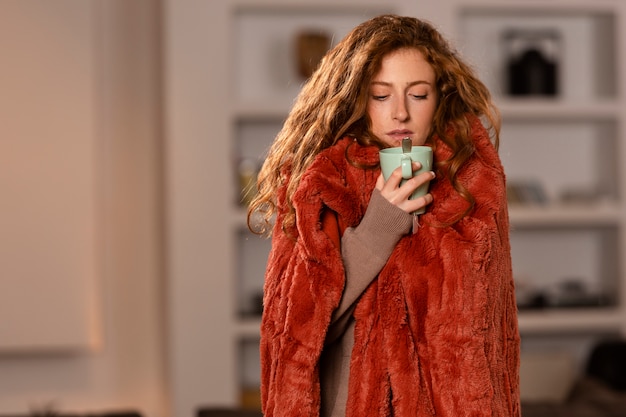 Medium shot woman holding tea cup