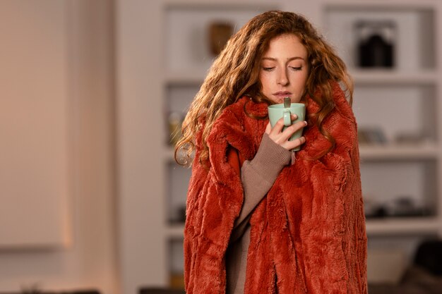 Medium shot woman holding tea cup