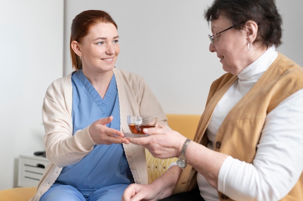 Medium shot woman holding tea