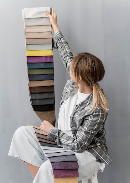 Medium shot woman holding textiles