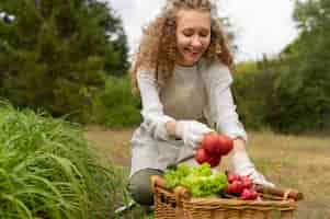 Foto gratuita pomodori della holding della donna del colpo medio