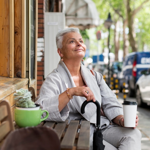 Free photo medium shot woman holding umbrella