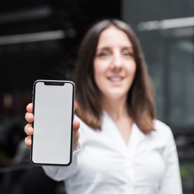 Medium shot woman holding up a smartphone