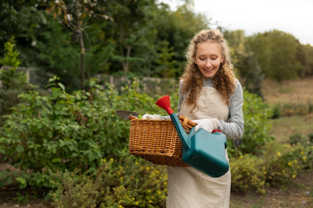 Medium shot woman holding watering can