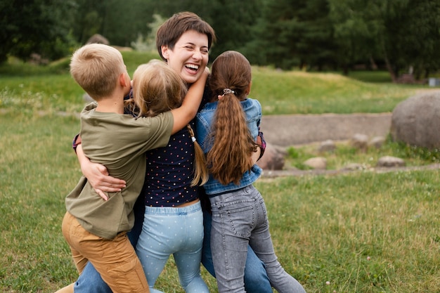 Medium shot woman hugging kids