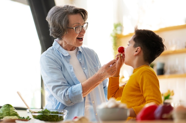 Free photo medium shot woman and kid cooking together