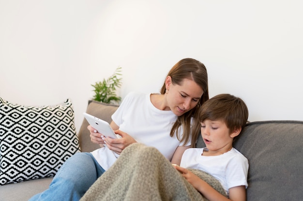 Medium shot woman and kid on couch