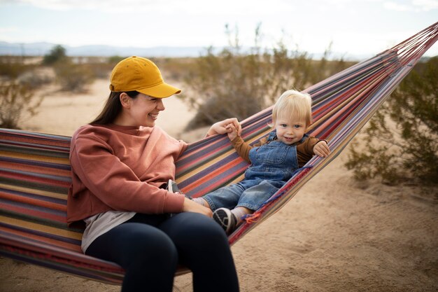 Medium shot woman and kid on hammock