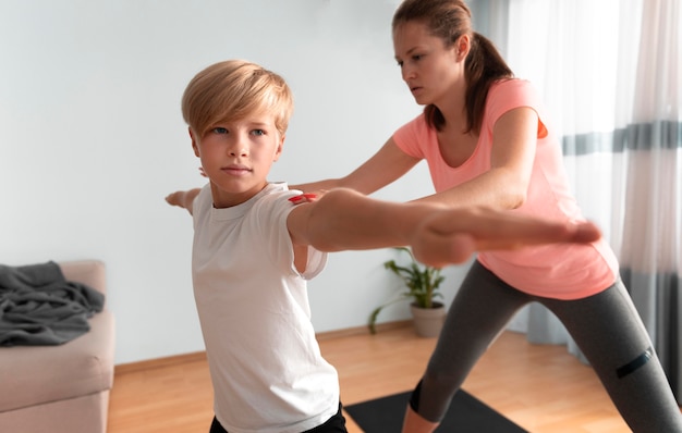 Medium shot woman and kid indoors