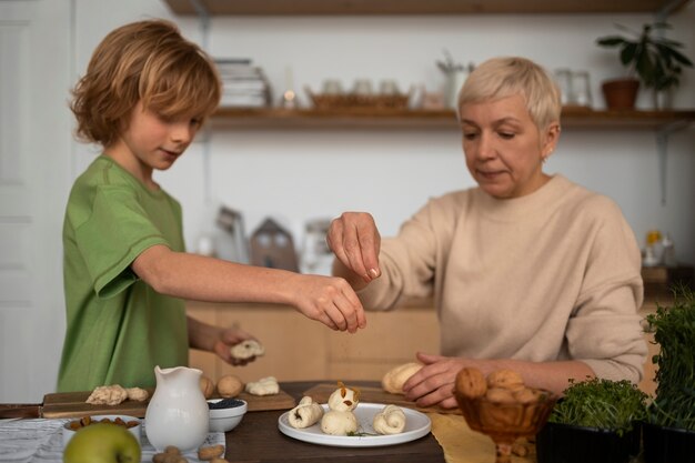 Medium shot woman and kid preparing food