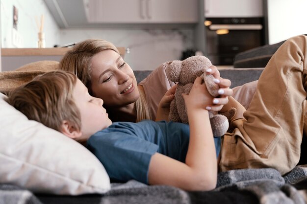 Medium shot woman and kid with toy