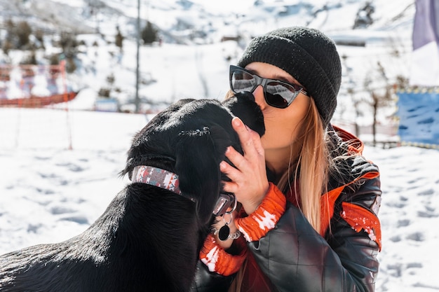 Medium shot woman kissing dog