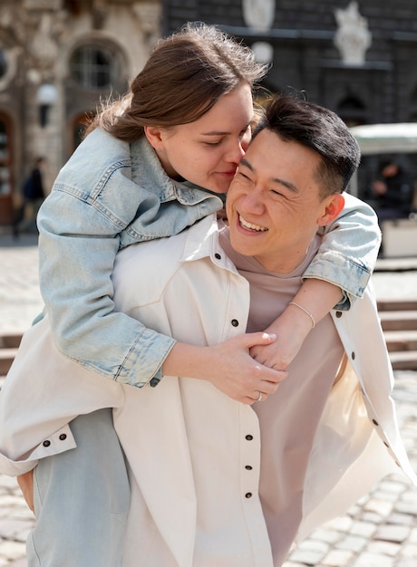 Medium shot woman kissing man on cheek