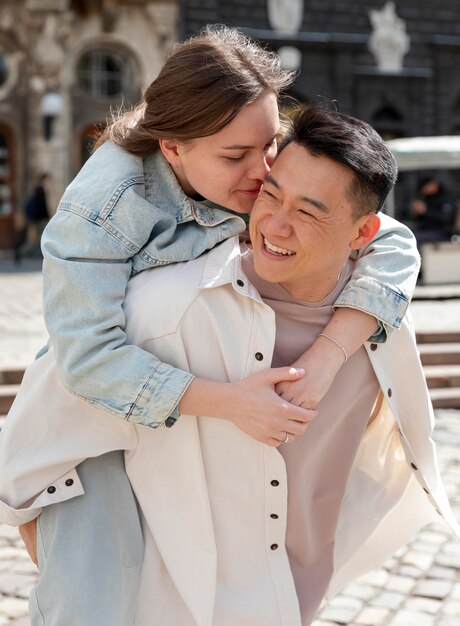 Medium shot woman kissing man on cheek