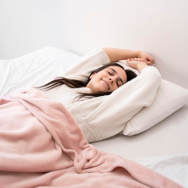 Medium shot woman laying in bed