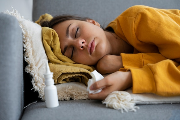 Free photo medium shot woman laying on couch