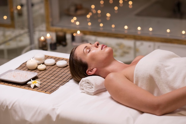 Medium shot woman laying on towel