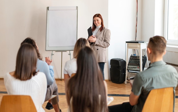 Medium shot woman leading therapy meeting