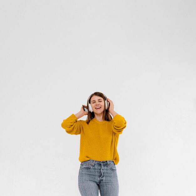 Medium shot woman listening to music