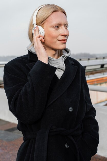 Medium shot woman listening to music