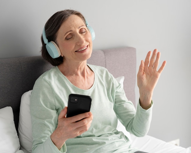 Medium shot woman listening to music