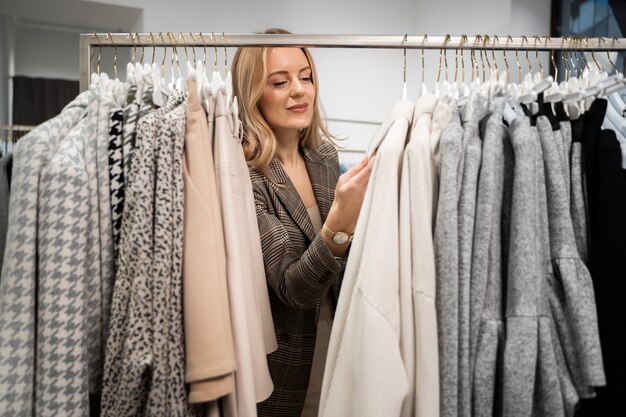 medium shot woman looking at clothes