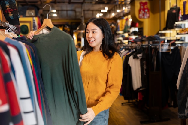 Free photo medium shot woman looking at clothes