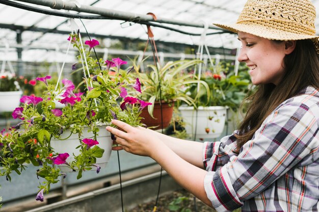 Medium shot woman looking at flowers