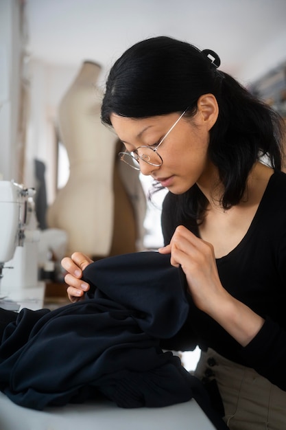 Medium shot woman looking at material