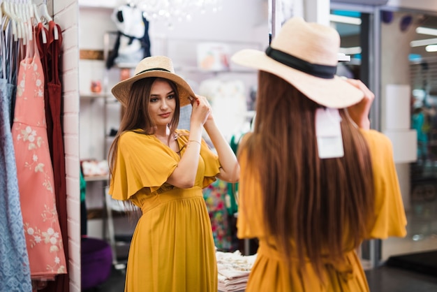 Medium shot woman looking in a mirror