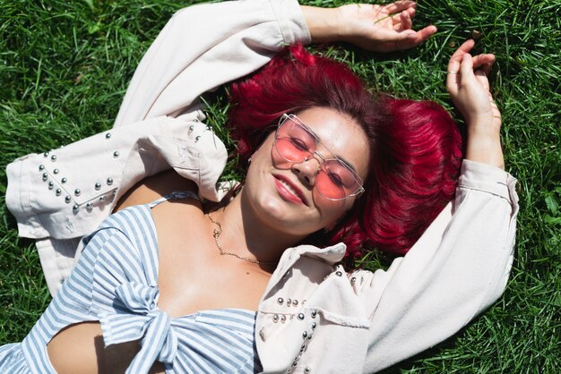 Medium shot of woman lying in grass