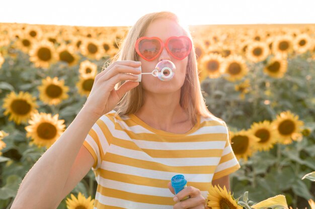 Medium shot woman making soap bubbles