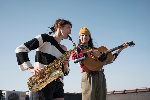 Medium shot woman and man making music