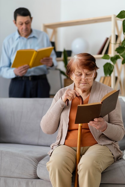 Medium shot woman and man reading