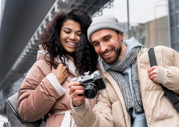 Medium shot woman and man with camera