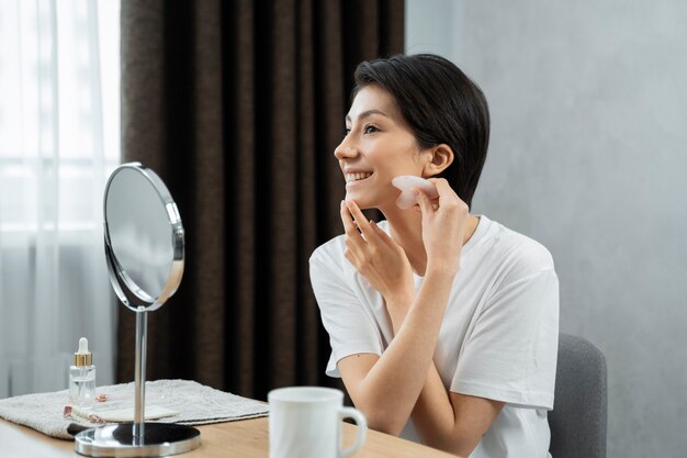 Medium shot woman massaging face