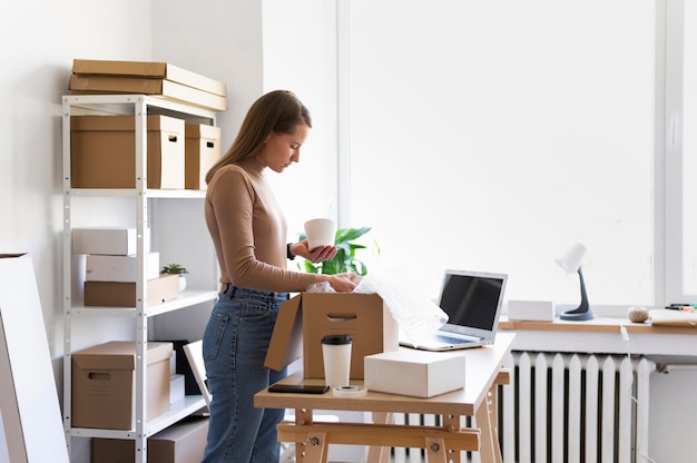 Medium shot woman packing pot