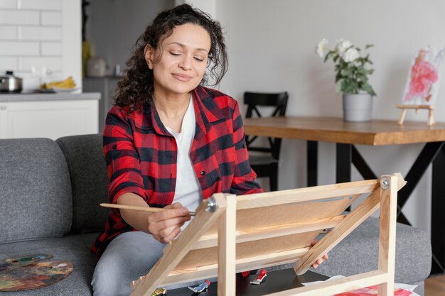 Medium shot woman painting as hobby