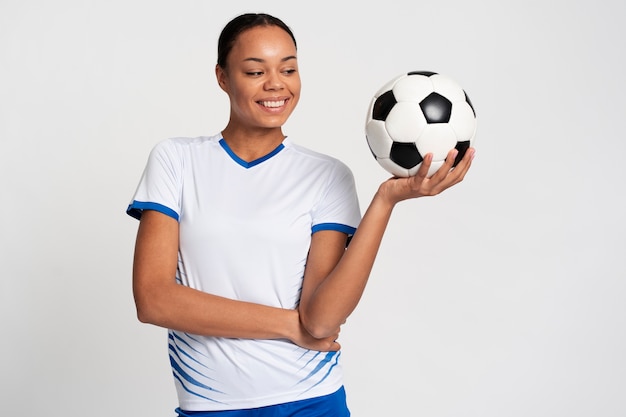 Free photo medium shot woman playing football