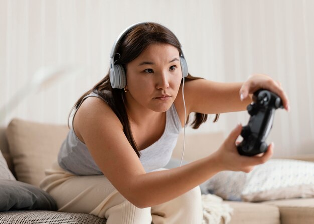 Medium shot woman playing game at home