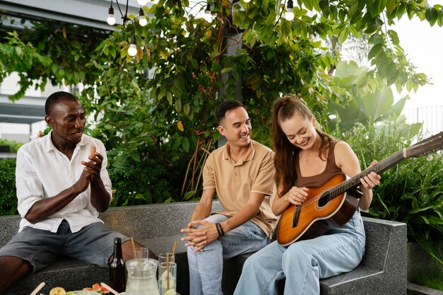 Medium shot woman playing the guitar