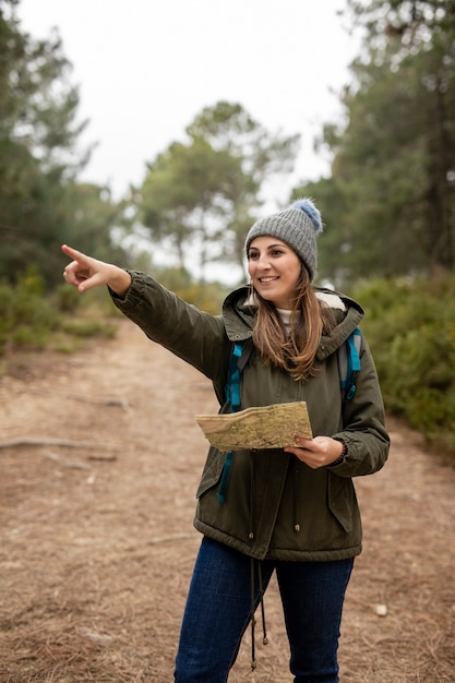 Free photo medium shot woman pointing at something