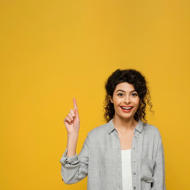 Medium shot woman pointing up