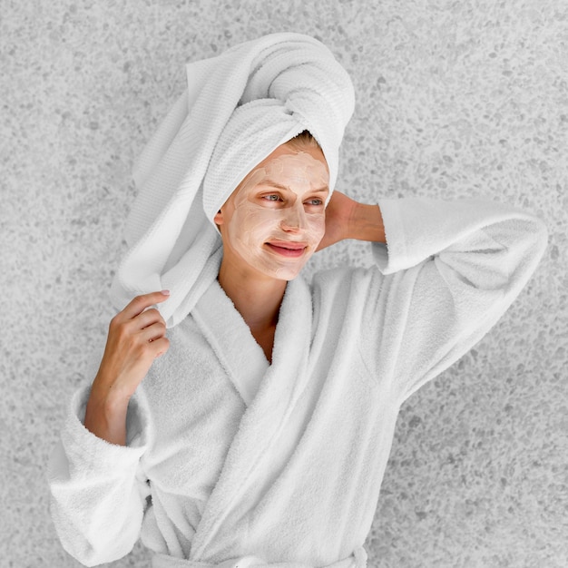 Medium shot woman posing in bathrobe