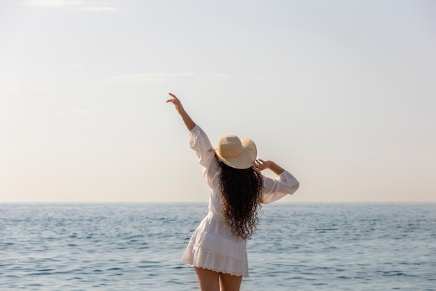 Medium shot woman posing at beach