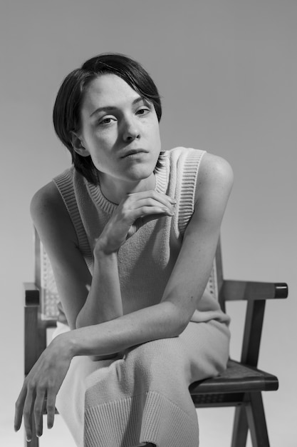 Medium shot woman posing on chair