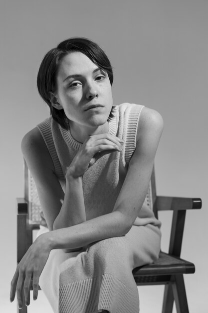 Medium shot woman posing on chair